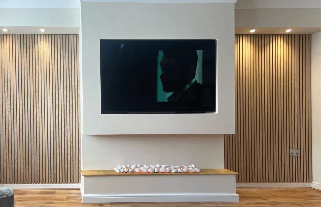 Large TV wall with CNC cut side panels in white