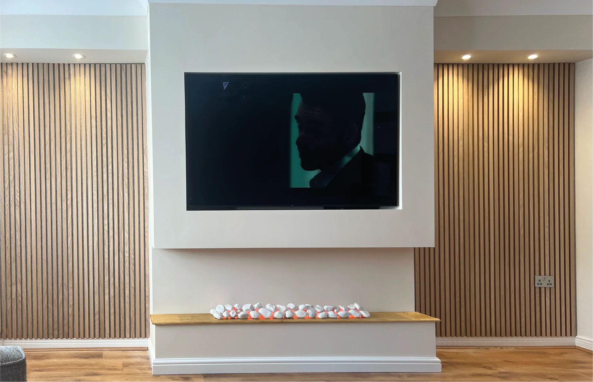 Large TV wall with CNC cut side panels in white