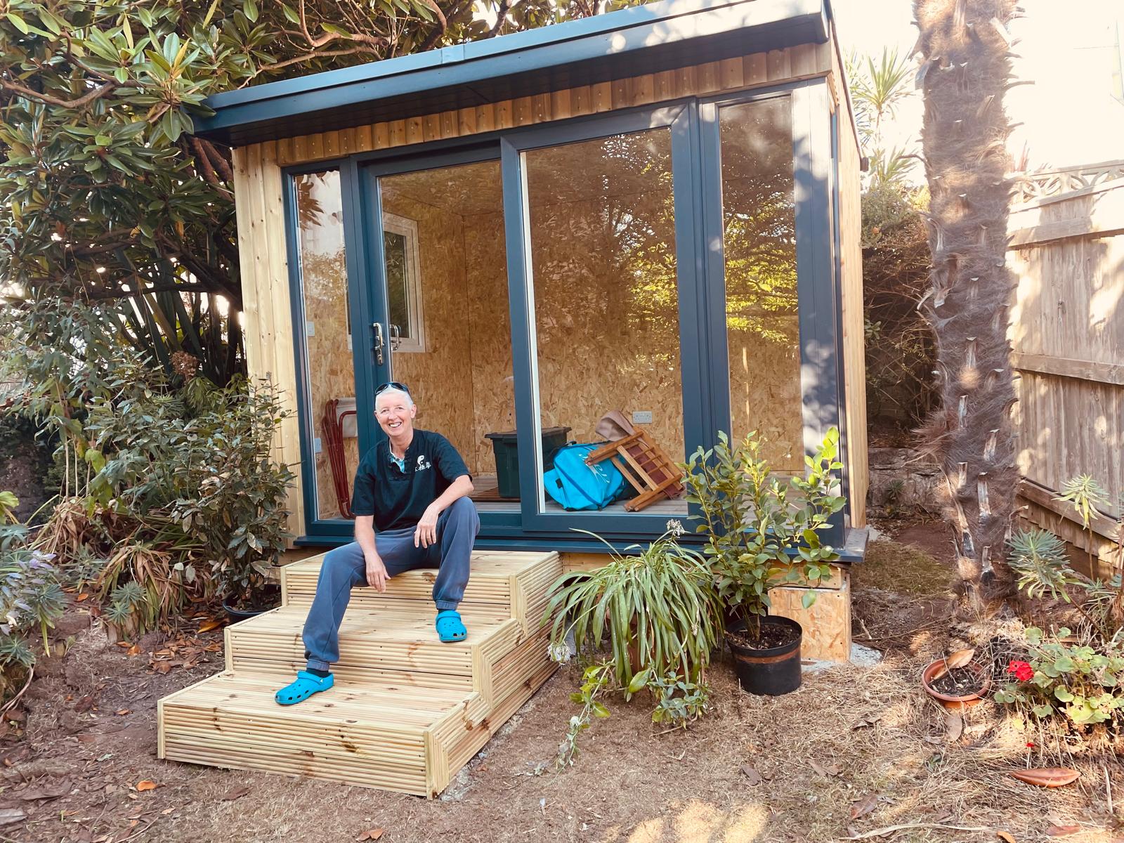 Glazed timber room with steps down to the garden